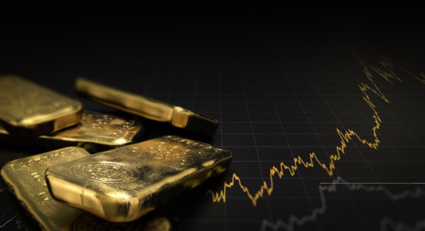 Goldbarren auf dunklem Hintergrund mit einem goldenen Kurvendiagramm im Hintergrund.
